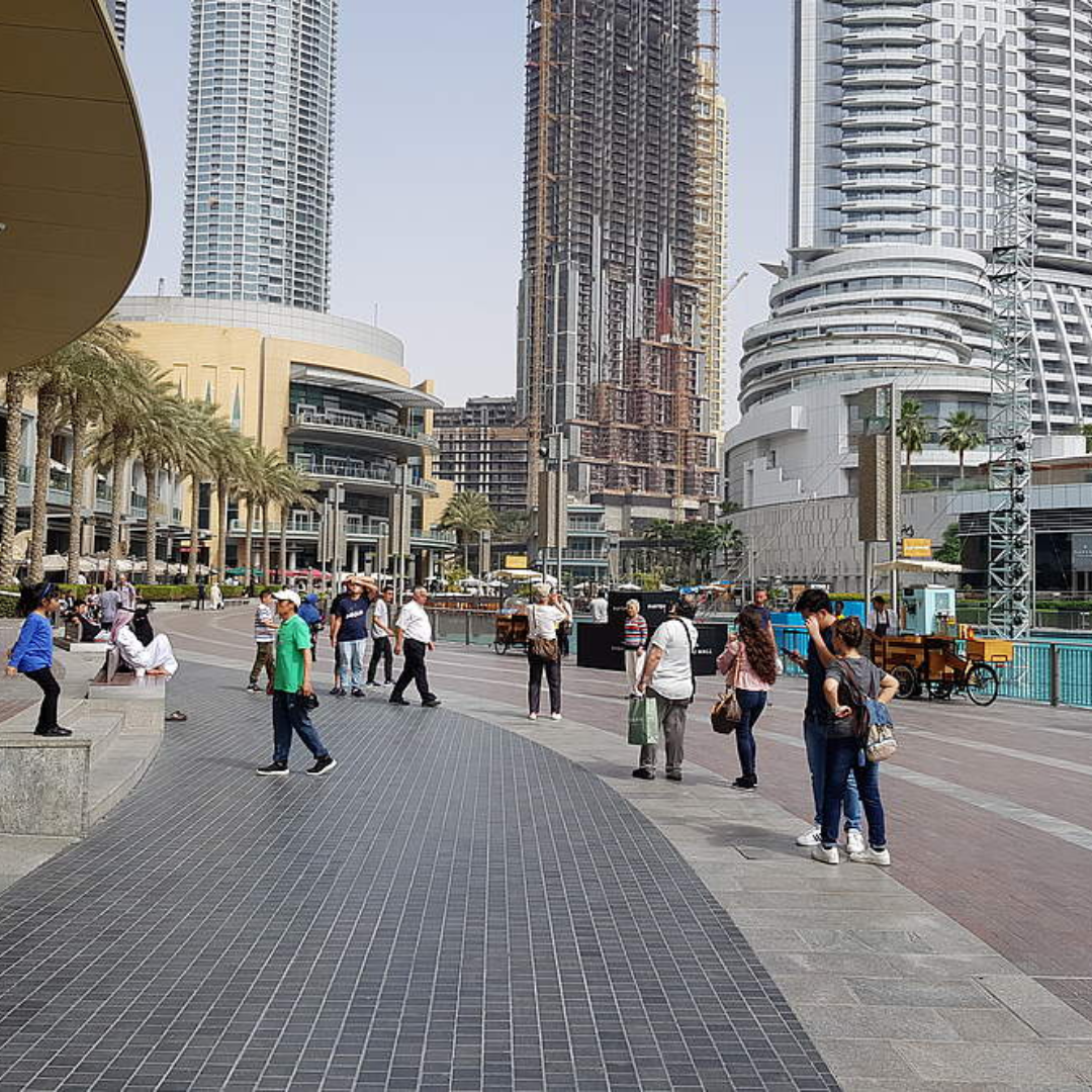 picture showing buildings and people who are walking on Dubai waterfront area 